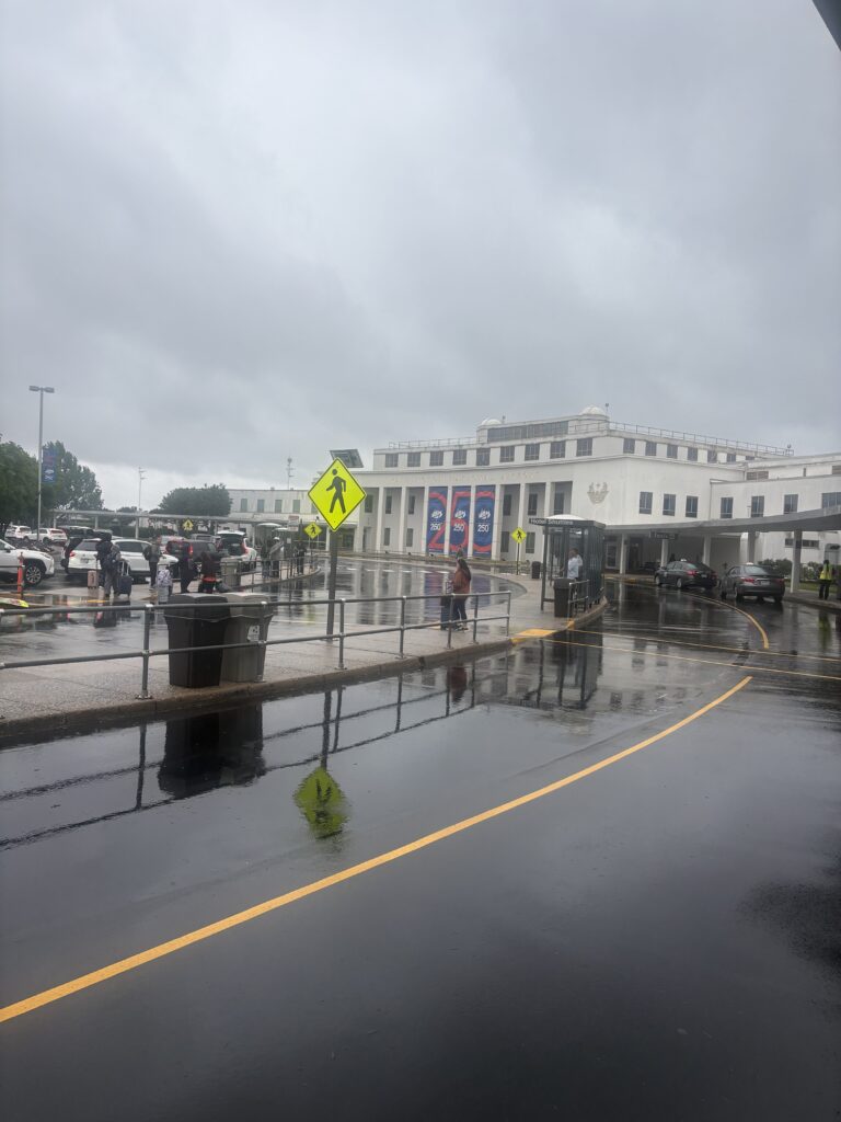 Reagan National Airport DCA terminal exterior curbside pickup rainy day