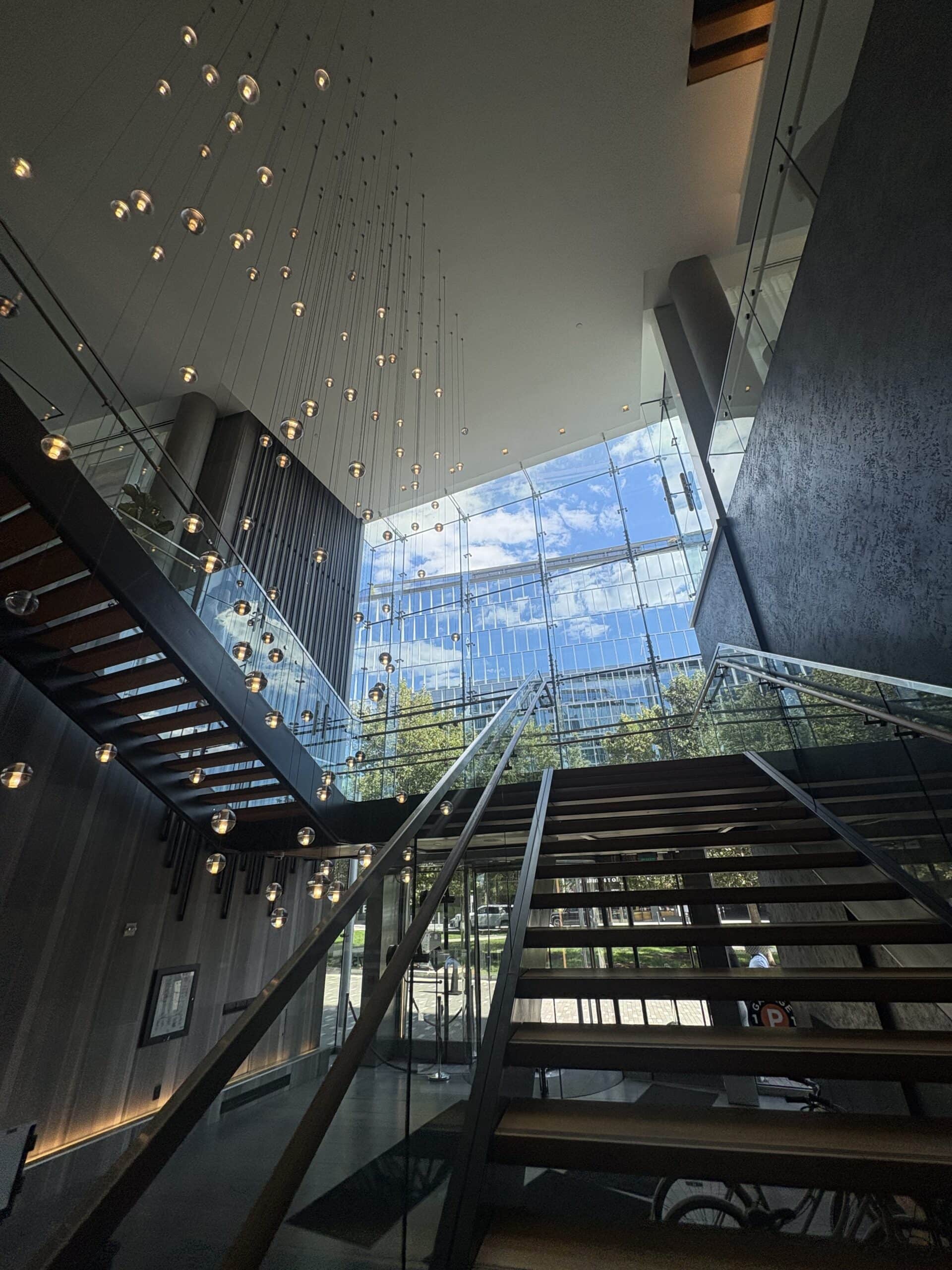 Open staircase and hanging light installation at the entrance of Canopy by Hilton Washington DC The Wharf
