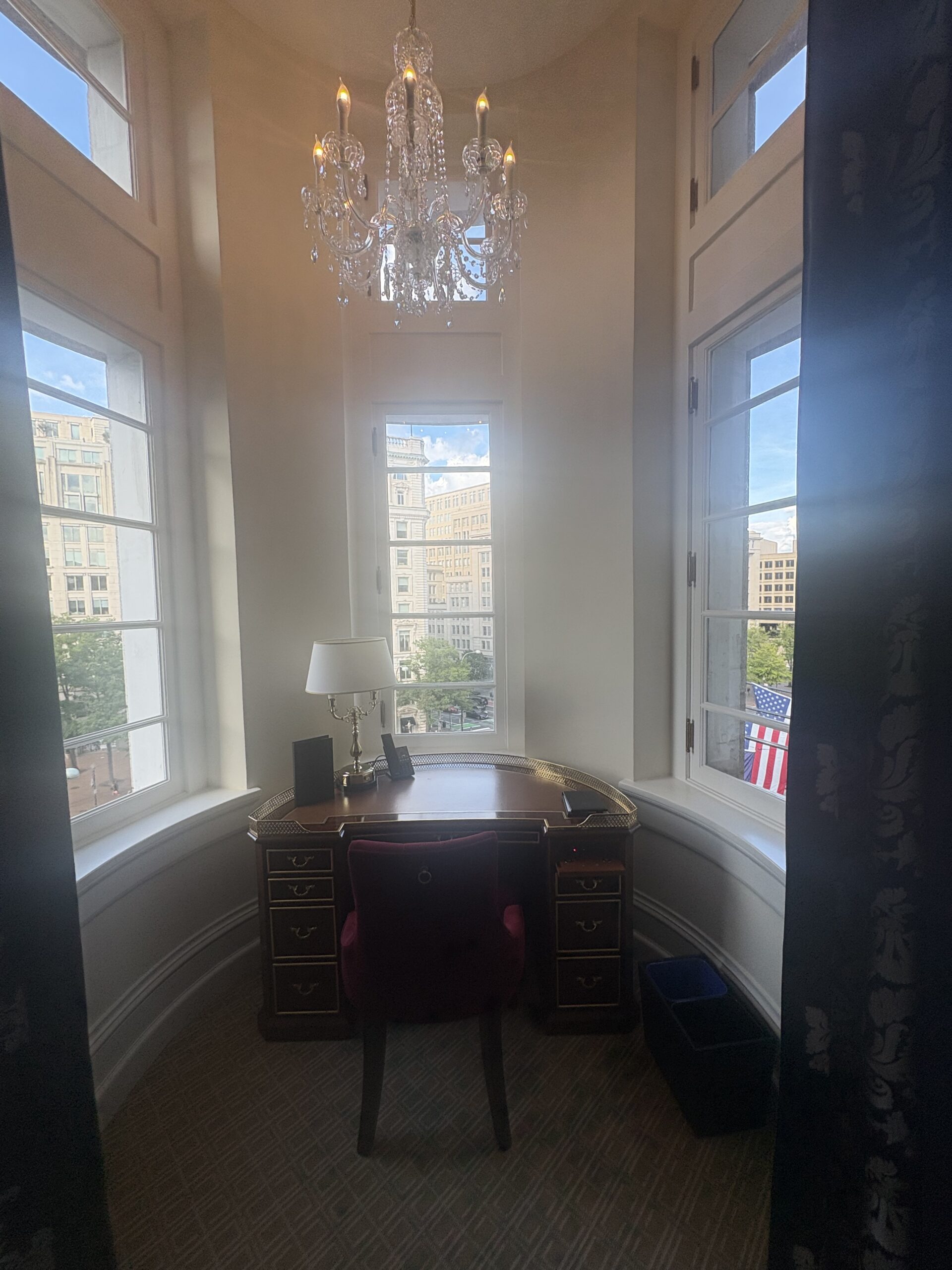 Round turret desk nook with crystal chandelier and arched windows at Waldorf Astoria Washington DC